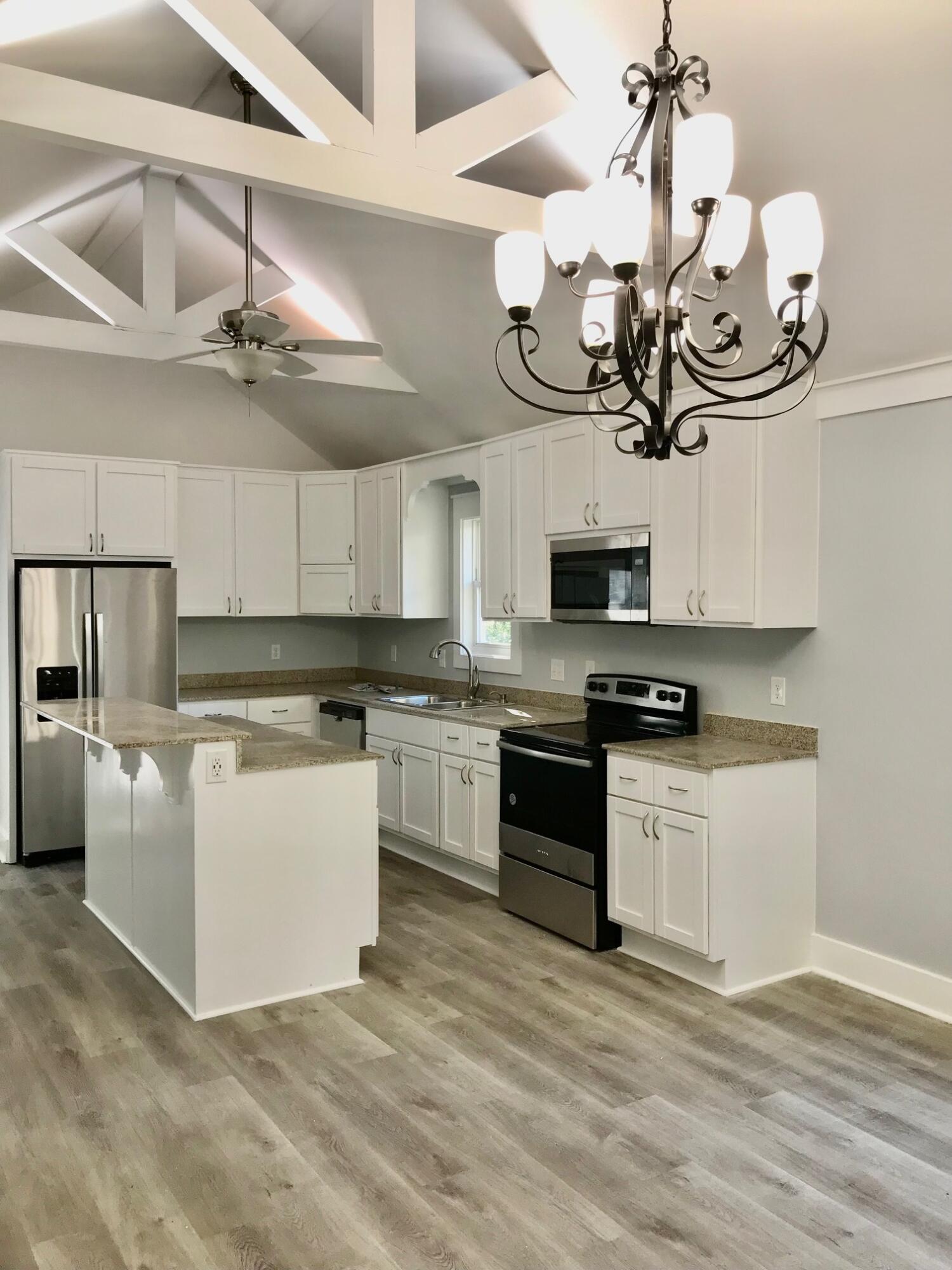 8 Sally Lane Santa Rosa Beach, FL 32459 - Photo 7 of 17 a kitchen with a sink stainless steel appliances and chandelier