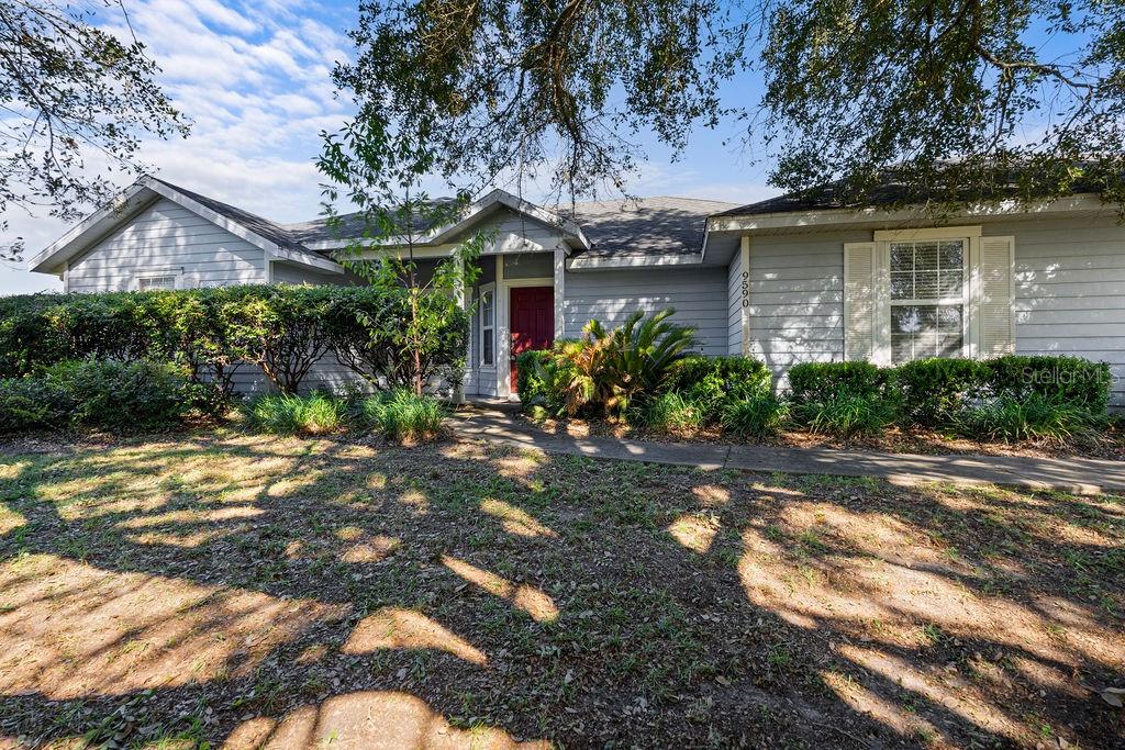 9590 Southwest 98th Avenue Gainesville, FL 32608 - Photo 2 of 25 a front view of a house with garden