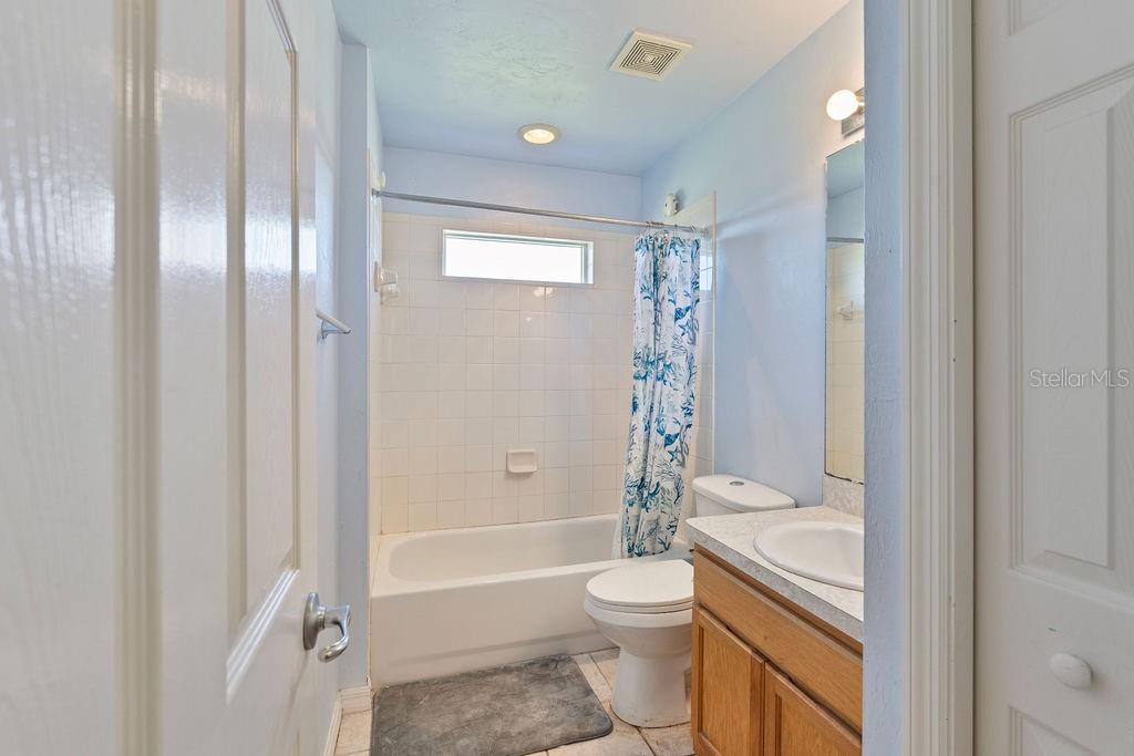 9590 Southwest 98th Avenue Gainesville, FL 32608 - Photo 21 of 25 a bathroom with a granite countertop bathtub shower sink vanity and toilet