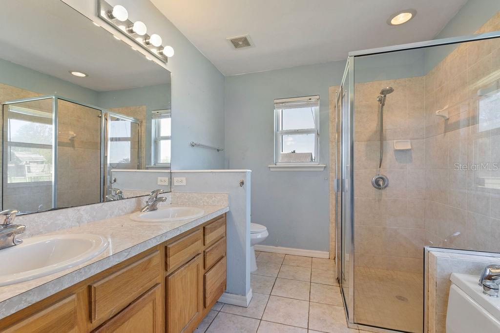 9590 Southwest 98th Avenue Gainesville, FL 32608 - Photo 23 of 25 a bathroom with a sink a toilet and shower