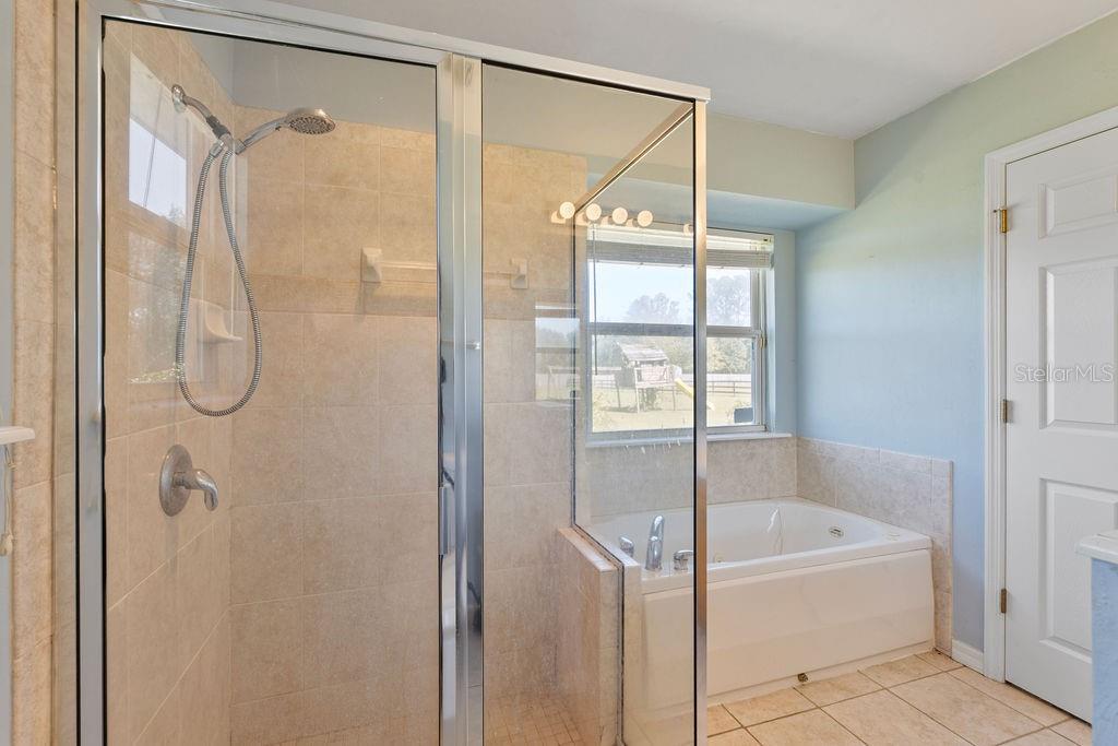 9590 Southwest 98th Avenue Gainesville, FL 32608 - Photo 24 of 25 a bathroom with a tub and shower