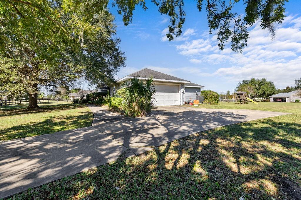 9590 Southwest 98th Avenue Gainesville, FL 32608 - Photo 5 of 25 a front view of a house with garden