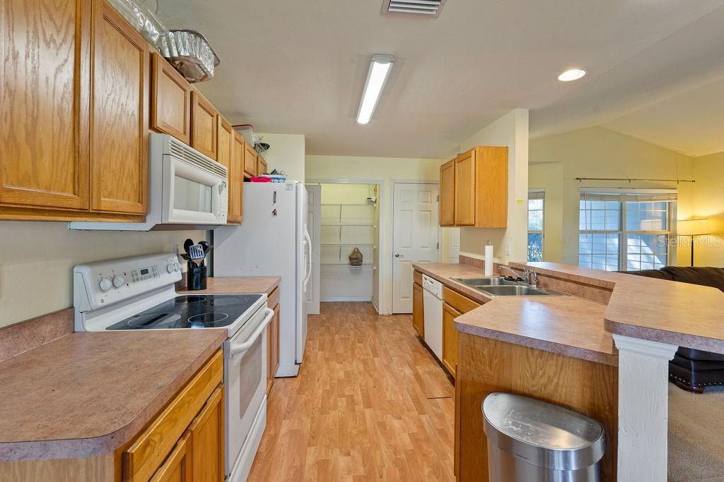 9590 Southwest 98th Avenue Gainesville, FL 32608 - Photo 6 of 25 a kitchen with a sink stove and cabinets