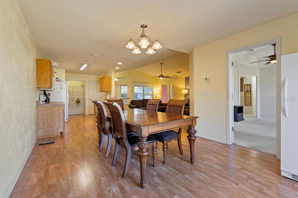 9590 Southwest 98th Avenue Gainesville, FL 32608 - Photo 7 of 25 a view of a dining room with furniture and wooden floor