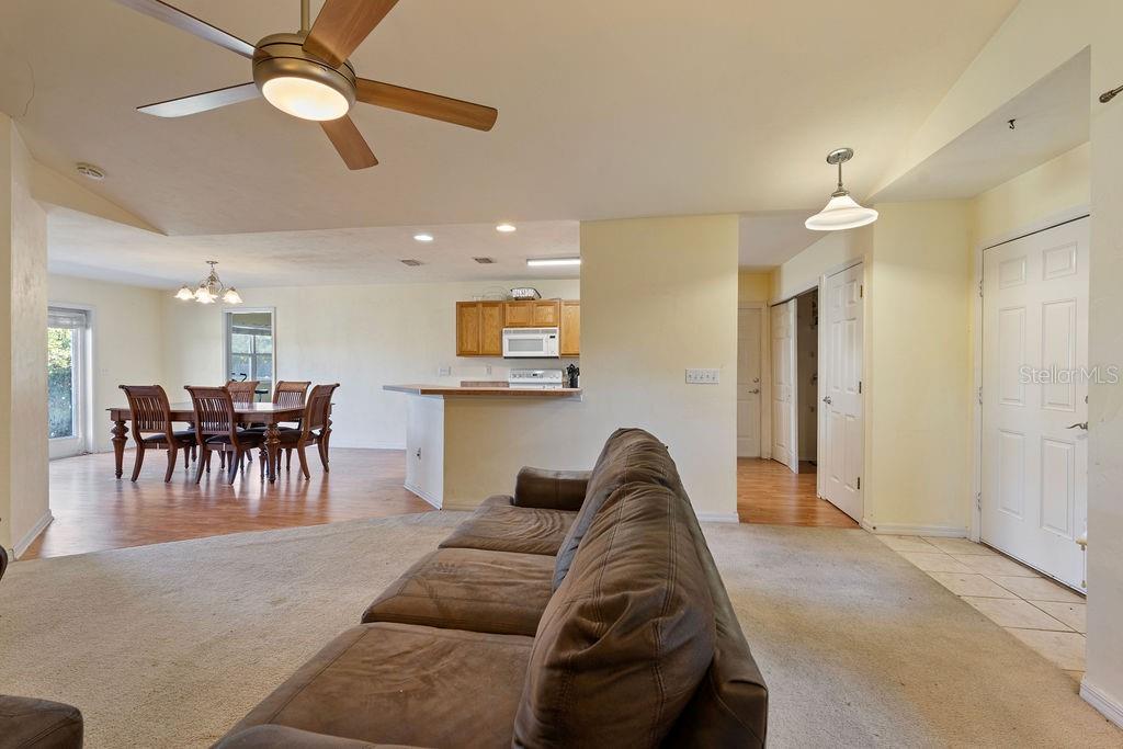 9590 Southwest 98th Avenue Gainesville, FL 32608 - Photo 8 of 25 a living room with furniture and a chandelier
