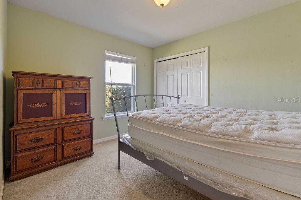 9590 Southwest 98th Avenue Gainesville, FL 32608 - Photo 10 of 25 a bedroom with a bed and furniture