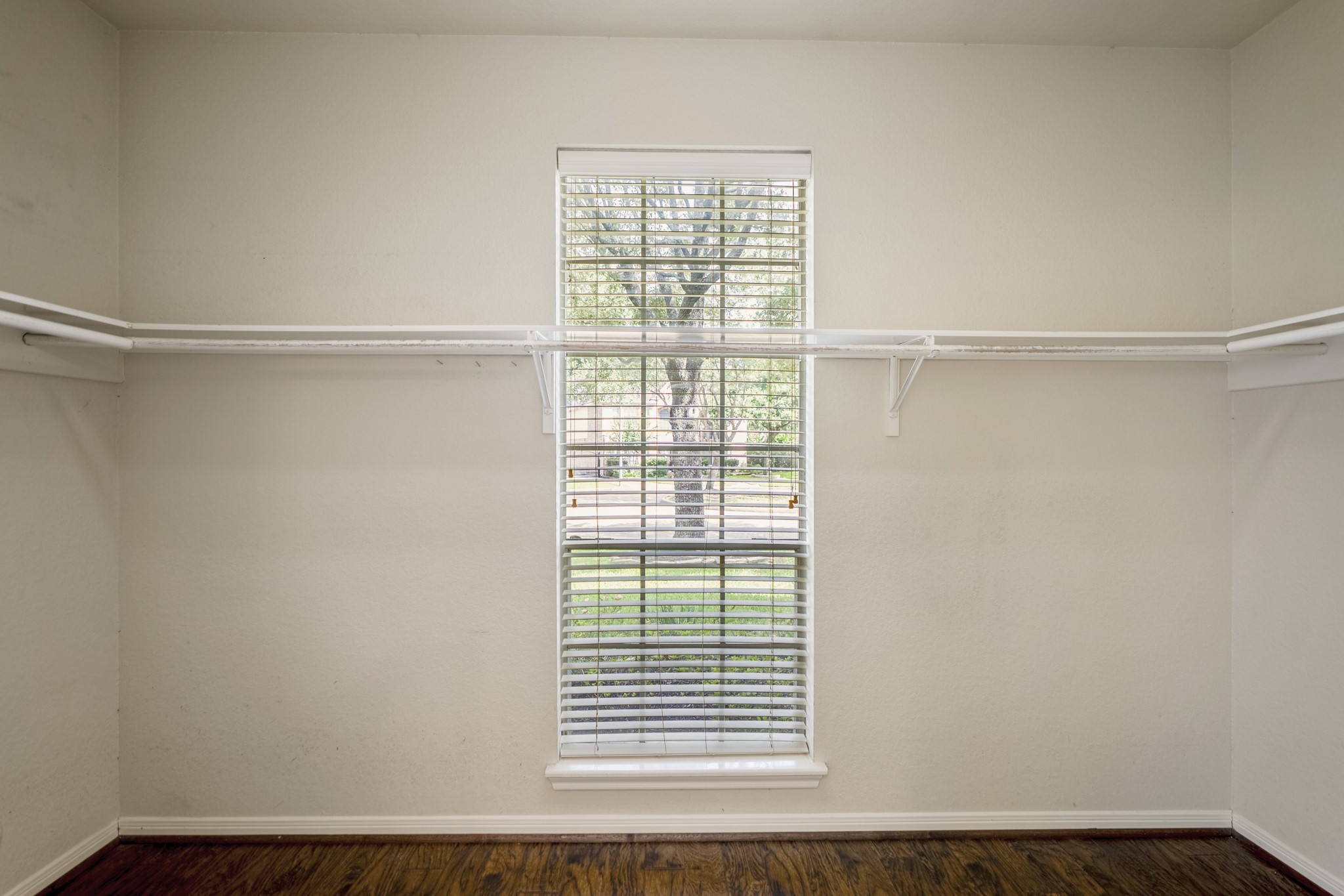 5807 Sequoia Trace Court Spring, TX 77379 - Photo 17 of 50 The primary suite includes a spacious walk-in closet with wraparound hanging space, built-in shelving, and a window that brings in natural light while keeping your wardrobe easy to organize and access.
