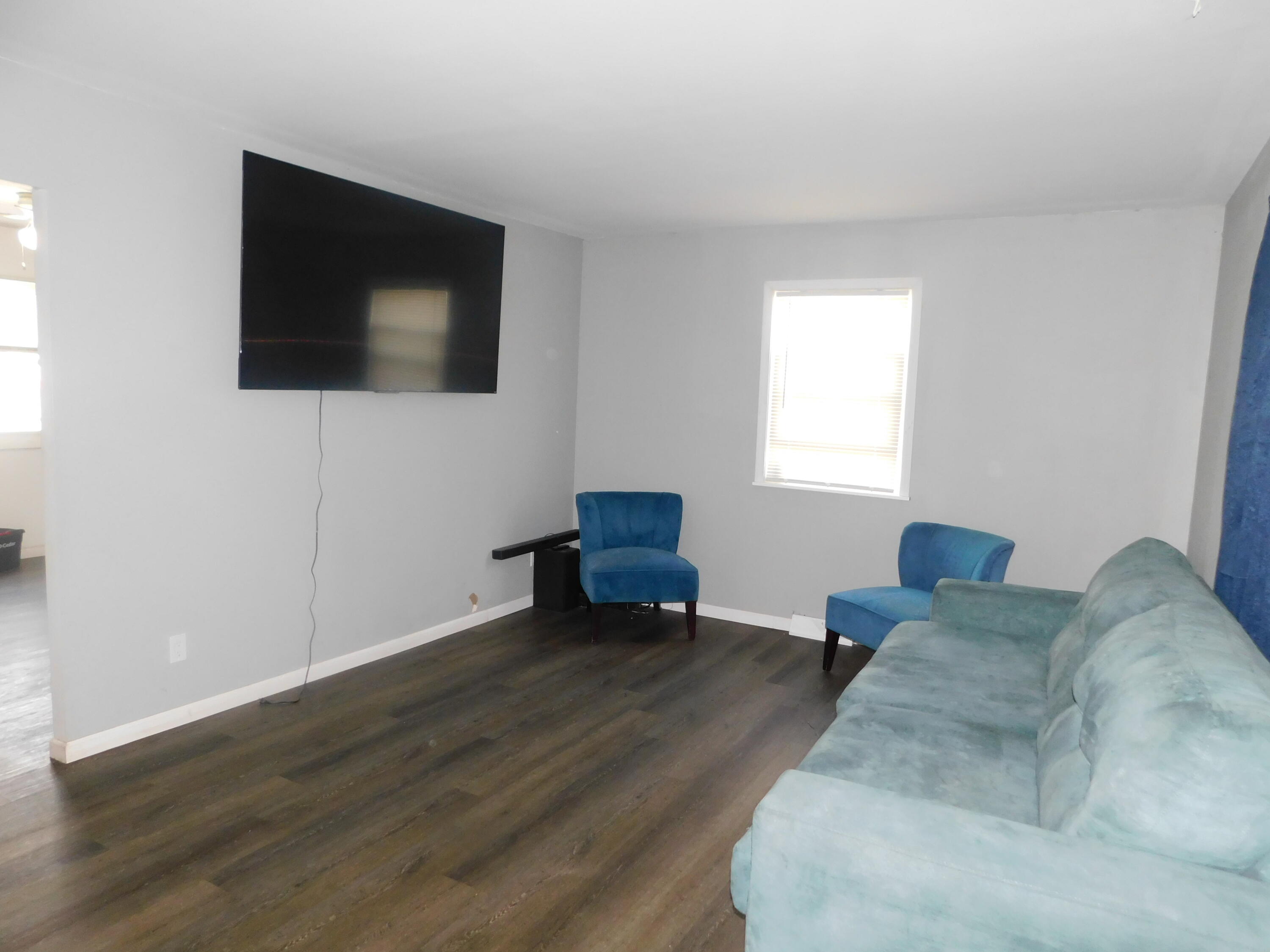 837 Spruce Street Hammond, IN 46324 - Photo 4 of 16 a living room with couches and a flat screen tv