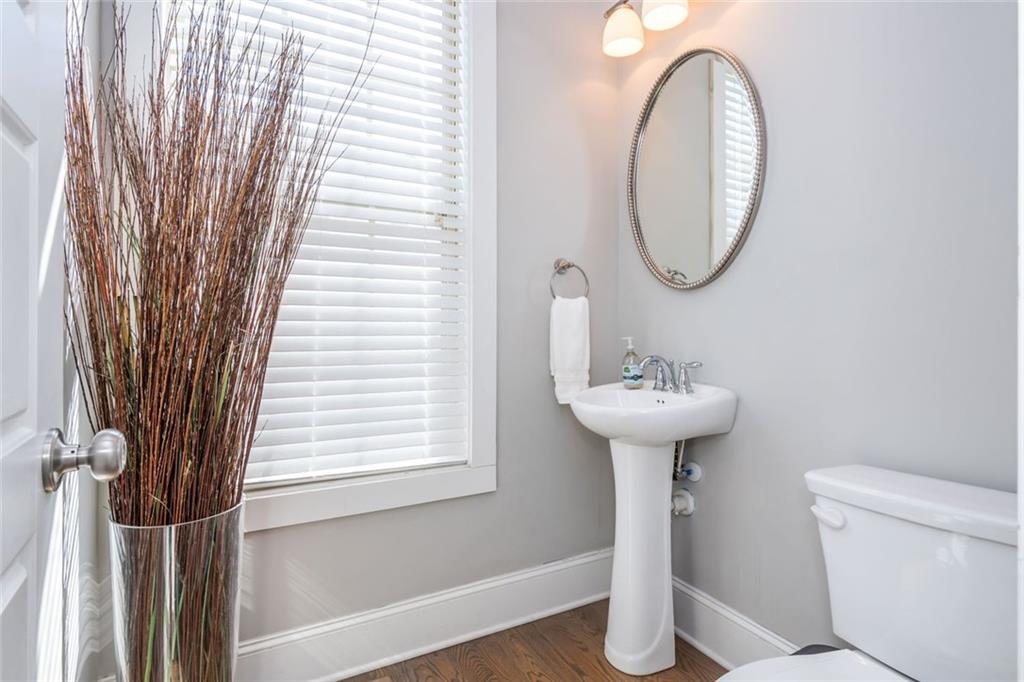 2138 Shale Lane Northwest, Unit 260 Atlanta, GA 30318 - Photo 16 of 39 a bathroom with a sink a mirror and a toilet