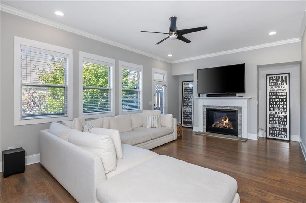 2138 Shale Lane Northwest, Unit 260 Atlanta, GA 30318 - Photo 17 of 39 a living room with furniture a fireplace and a flat screen tv
