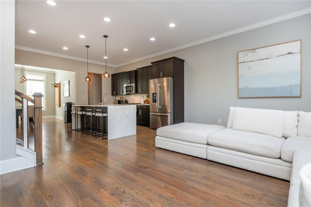 2138 Shale Lane Northwest, Unit 260 Atlanta, GA 30318 - Photo 19 of 39 a living room with stainless steel appliances furniture wooden floor and a kitchen view
