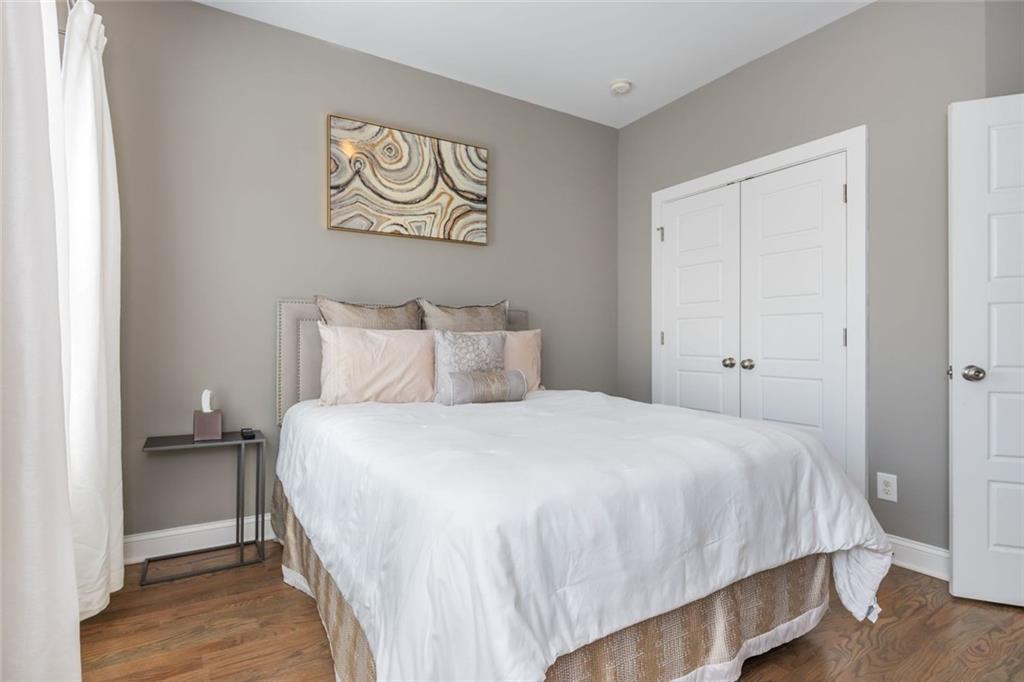 2138 Shale Lane Northwest, Unit 260 Atlanta, GA 30318 - Photo 29 of 39 a bedroom with a bed and a painting on the wall