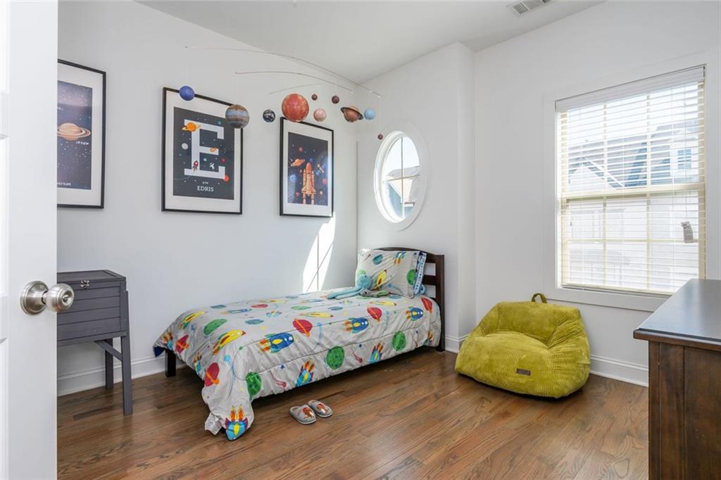 2138 Shale Lane Northwest, Unit 260 Atlanta, GA 30318 - Photo 30 of 39 a bedroom with a bed and wooden floor