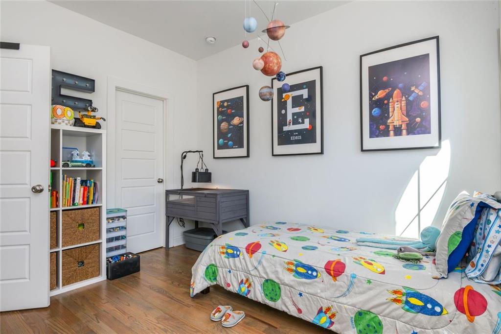 2138 Shale Lane Northwest, Unit 260 Atlanta, GA 30318 - Photo 31 of 39 a bedroom that has a bed and a bookshelf in it