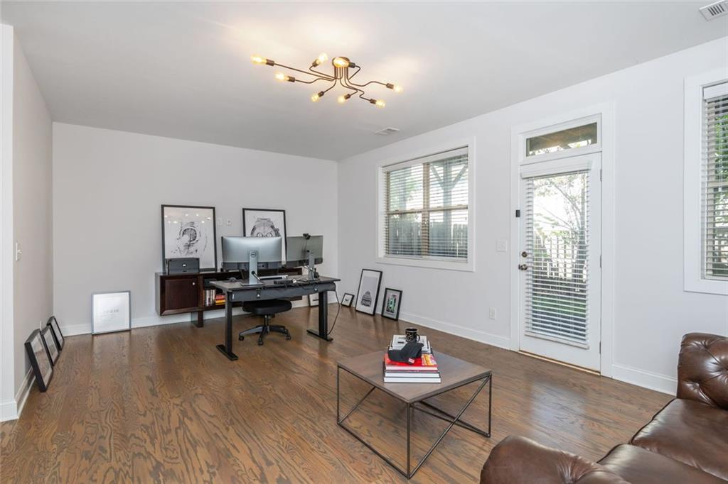 2138 Shale Lane Northwest, Unit 260 Atlanta, GA 30318 - Photo 34 of 39 a living room with furniture a piano and a window