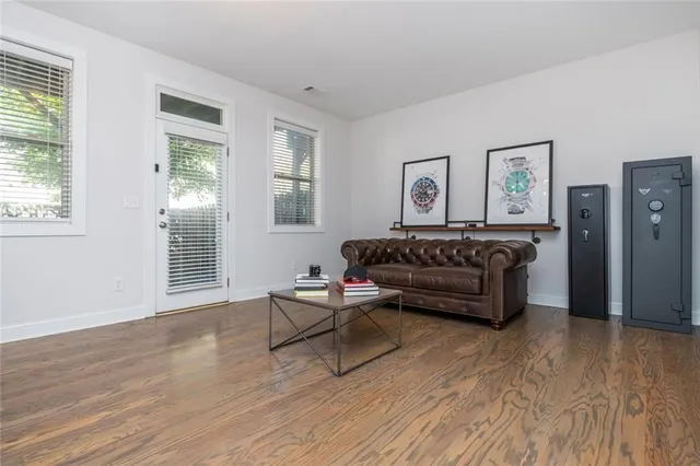 a living room with furniture and a wooden floor
