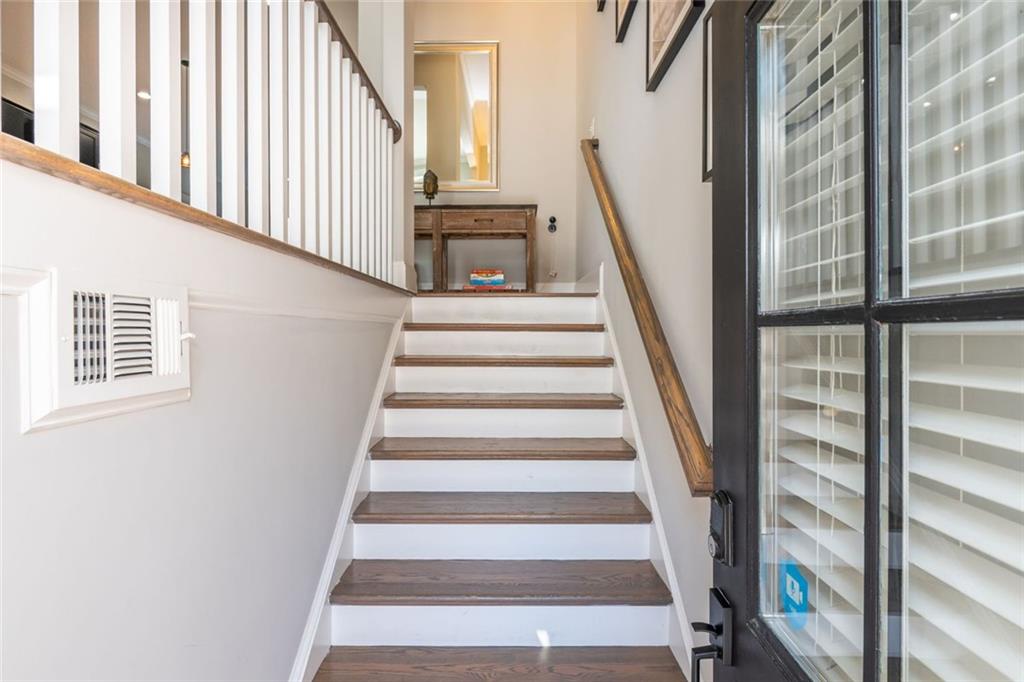 2138 Shale Lane Northwest, Unit 260 Atlanta, GA 30318 - Photo 4 of 39 a view of staircase with lots of frames on wall and a window