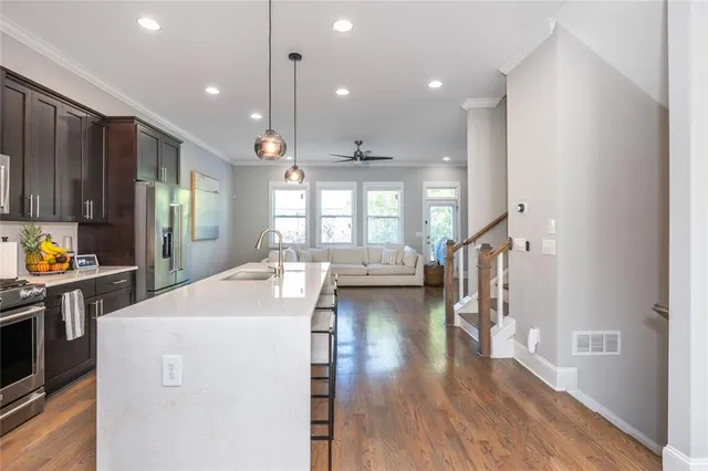 a kitchen with sink cabinets and wooden floor