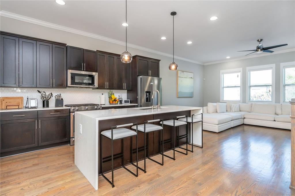 2138 Shale Lane Northwest, Unit 260 Atlanta, GA 30318 - Photo 6 of 39 a kitchen with sink cabinets and wooden floor
