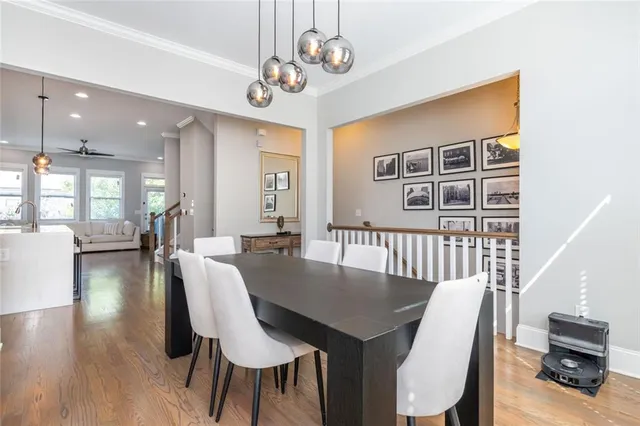 a view of a dining room with furniture wooden floor and chandelier