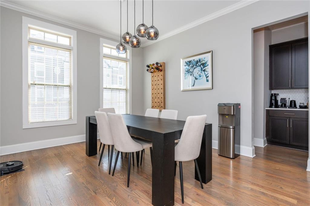 2138 Shale Lane Northwest, Unit 260 Atlanta, GA 30318 - Photo 9 of 39 a view of a dining room with furniture window and wooden floor