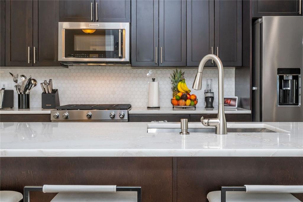 2138 Shale Lane Northwest, Unit 260 Atlanta, GA 30318 - Photo 10 of 39 a sink with a microwave and view of wooden cabinet