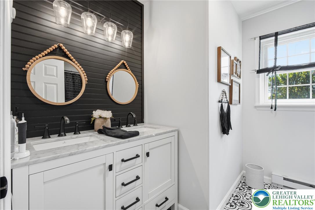 890 Lahr Road Nazareth, PA 18064 - Photo 31 of 71 Dual vanities with elegant black hardware enhance this modern and functional primary bathroom.