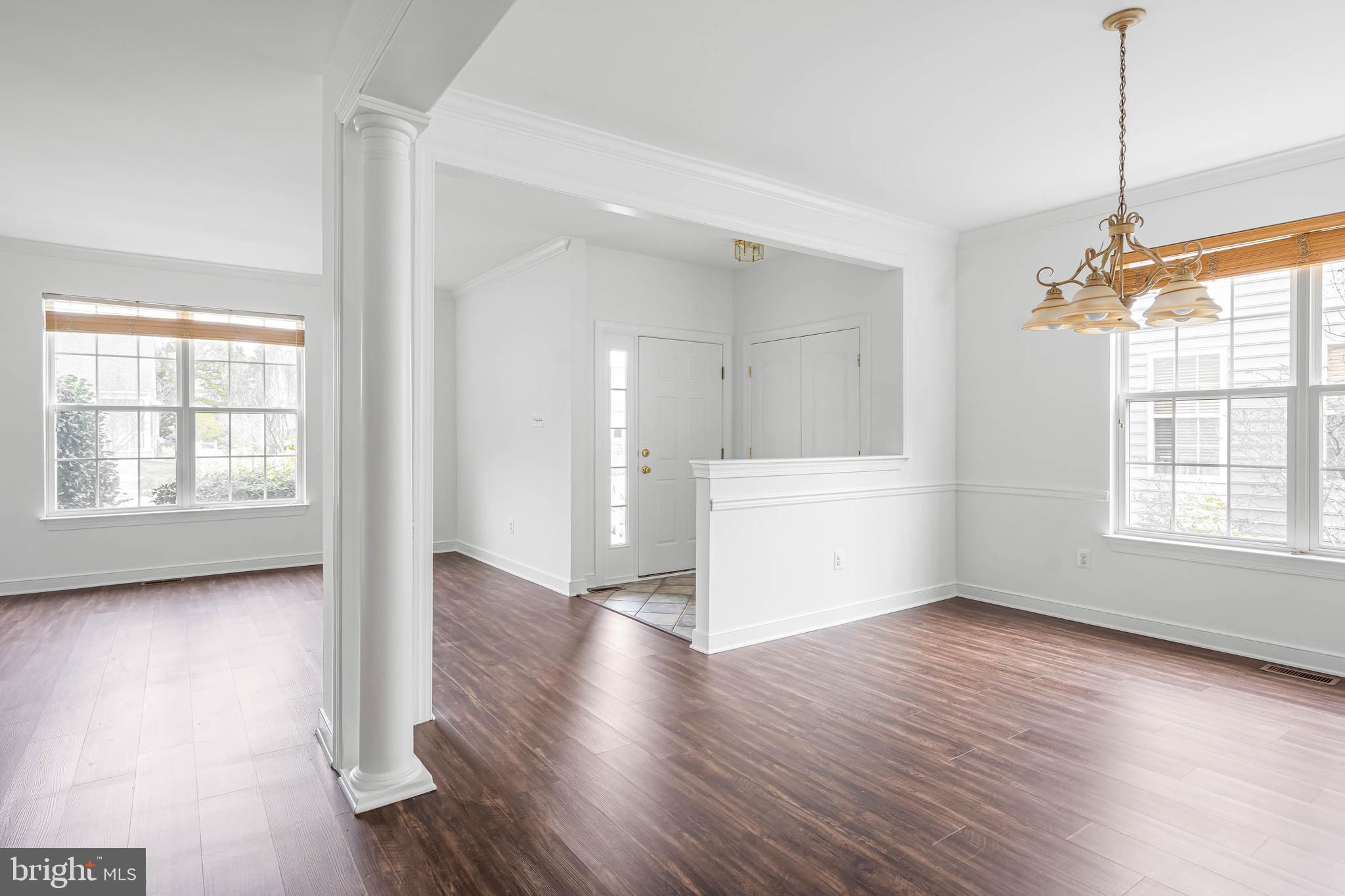 35560 Dry Brook Drive Rehoboth Beach, DE 19971 - Photo 11 of 63 a view of an empty room with wooden floor and a window