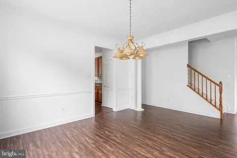 a kitchen with stainless steel appliances granite countertop wooden cabinets granite counter tops and a hard wood floors