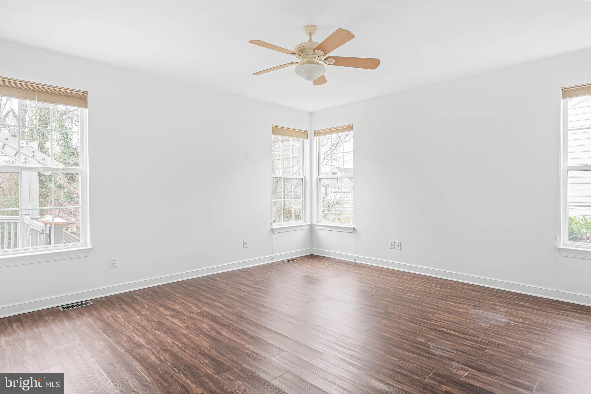 35560 Dry Brook Drive Rehoboth Beach, DE 19971 - Photo 31 of 63 an empty room with wooden floor windows and fan