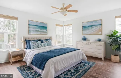 a bathroom with a granite countertop sink a toilet and a tub