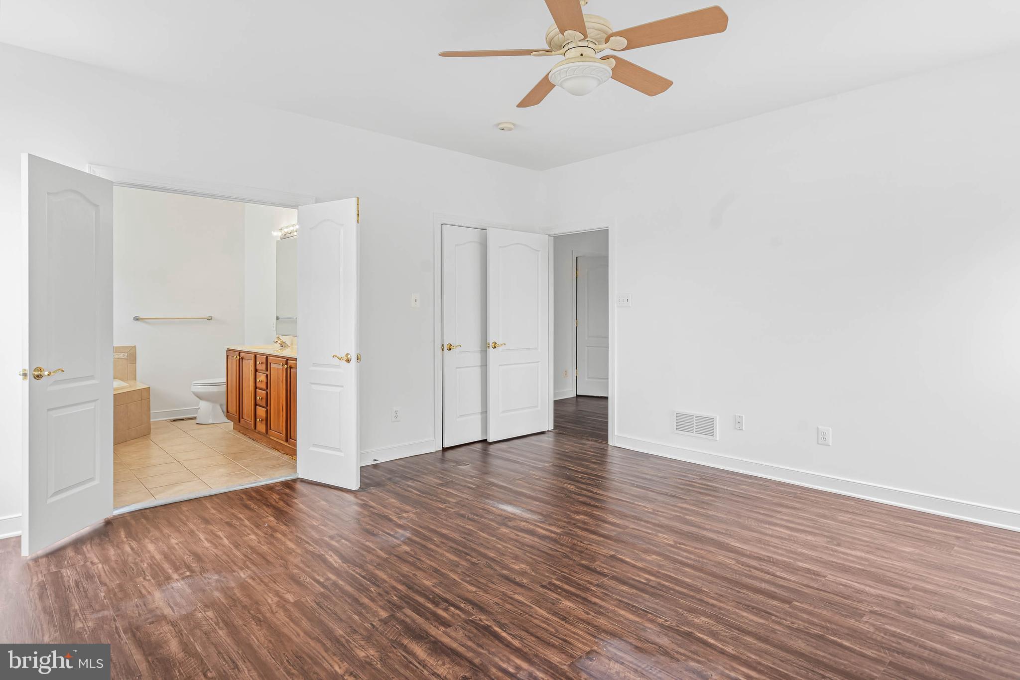 35560 Dry Brook Drive Rehoboth Beach, DE 19971 - Photo 33 of 63 a view of an empty room with wooden floor and a ceiling fan