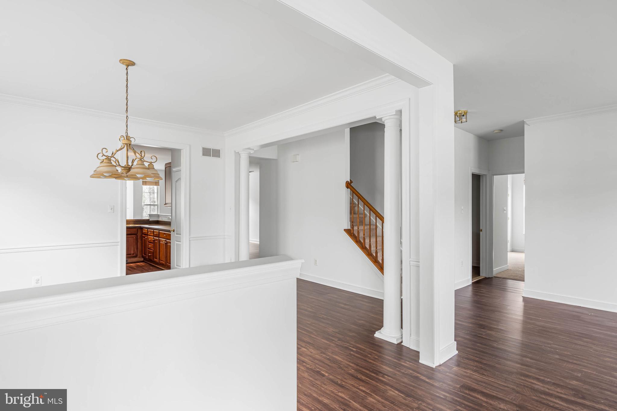 35560 Dry Brook Drive Rehoboth Beach, DE 19971 - Photo 6 of 63 a view of a room with wooden floor staircase and a kitchen space