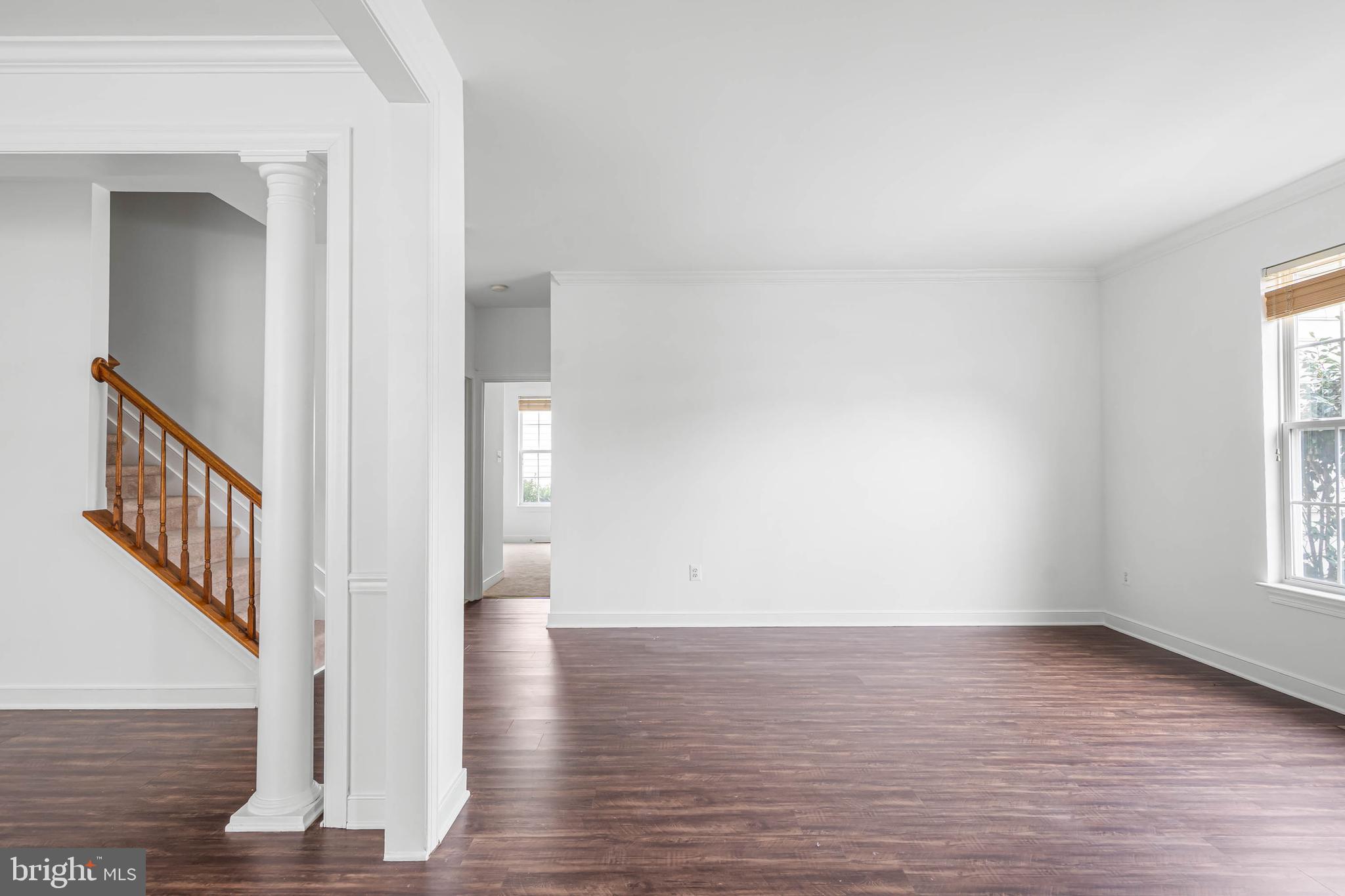 35560 Dry Brook Drive Rehoboth Beach, DE 19971 - Photo 7 of 63 a view of an empty room with wooden floor and a window