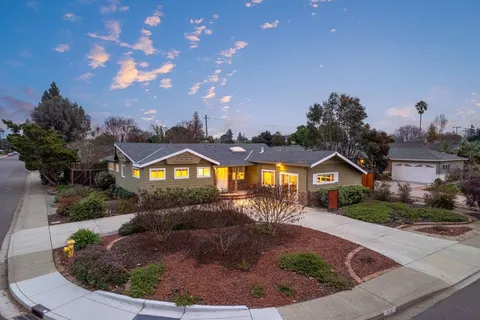 a front view of a house with a garden