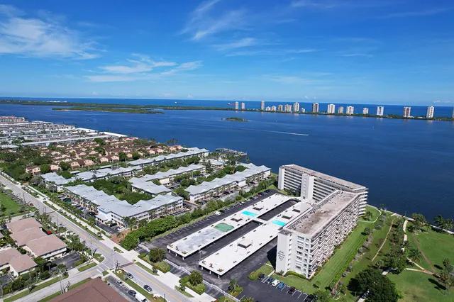 an aerial view of swimming pool a residential houses with outdoor space and swimming pool