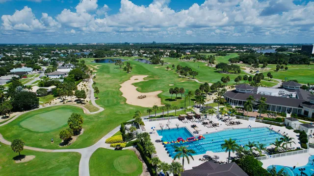 an aerial view of a residential houses with outdoor space and a lake view