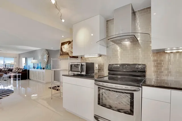 a kitchen with stove cabinets and stainless steel appliances