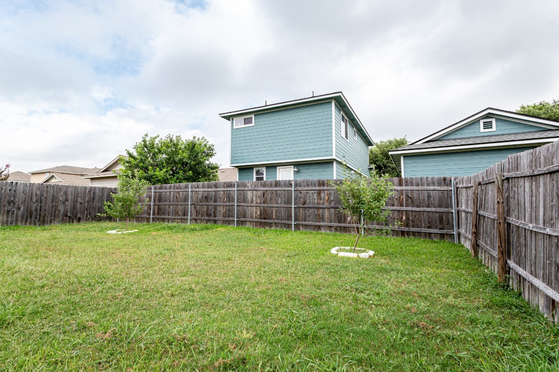 2724 Amberglow Court Round Rock, TX 78665 - Photo 18 of 18 a backyard of a house with lots of green space and trampoline