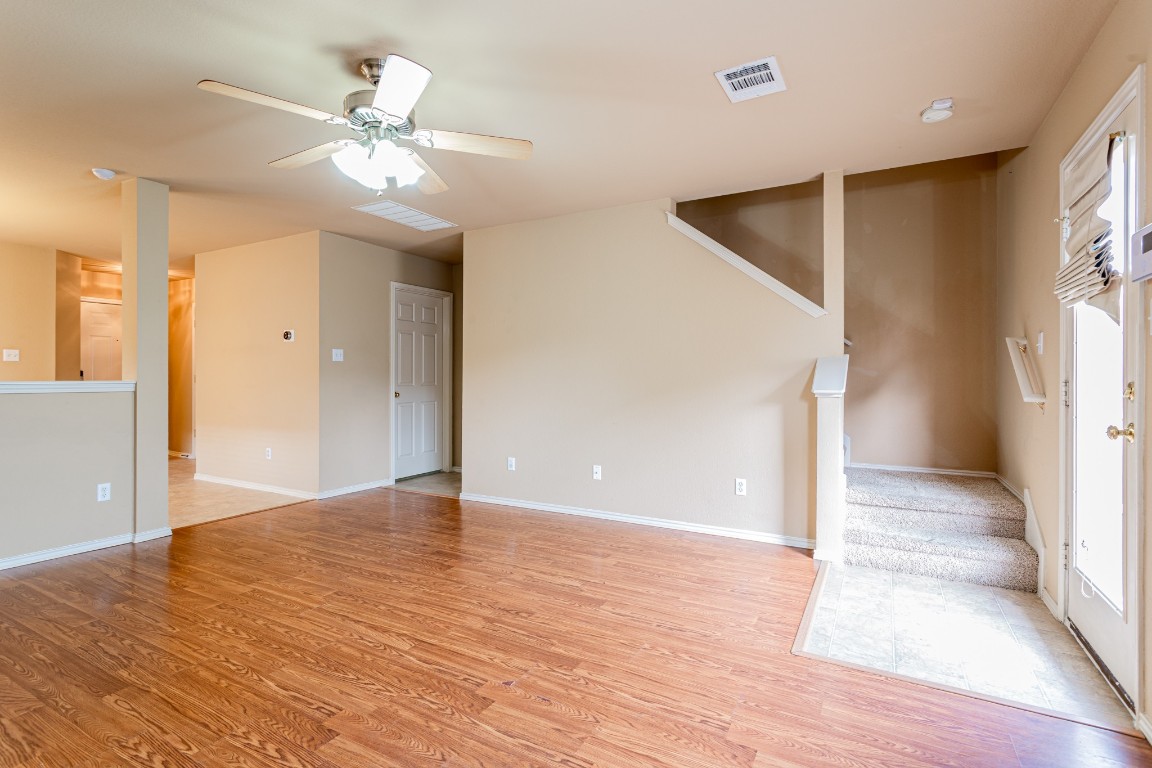 2724 Amberglow Court Round Rock, TX 78665 - Photo 3 of 18 a view of an empty room with wooden floor and a window