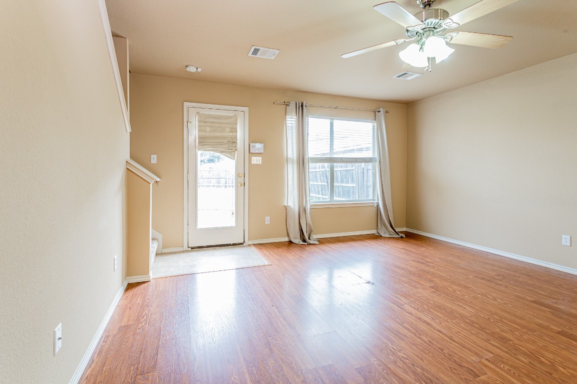 2724 Amberglow Court Round Rock, TX 78665 - Photo 4 of 18 wooden floor in an empty room with a window