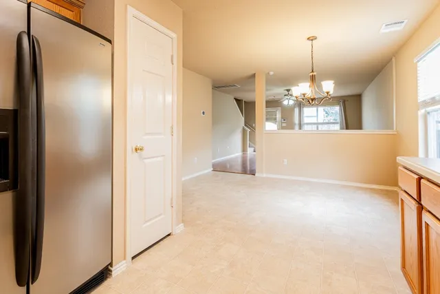a view of a hallway with chandelier and chandelier