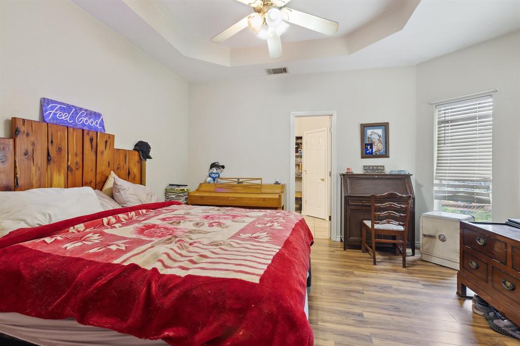 118 Cagle Quinlan, TX 75474 - Photo 11 of 23 a bedroom with a bed and a chandelier