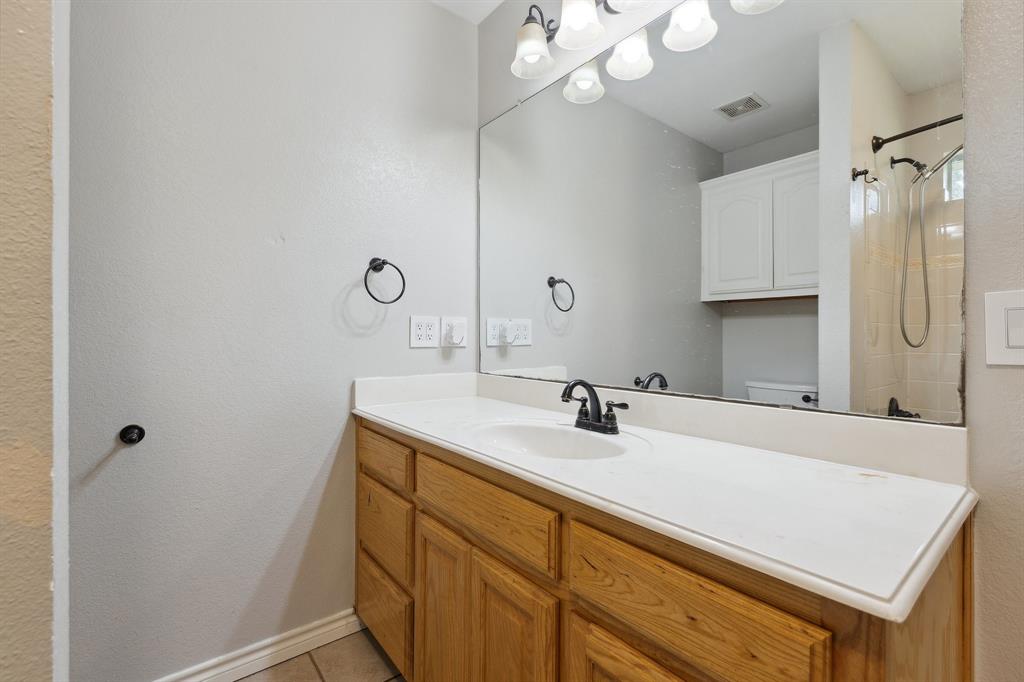118 Cagle Quinlan, TX 75474 - Photo 12 of 23 a bathroom with a sink a vanity and a mirror