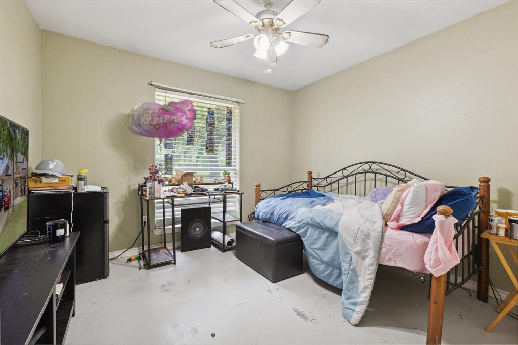 118 Cagle Quinlan, TX 75474 - Photo 13 of 23 a bedroom with a bed and a chandelier