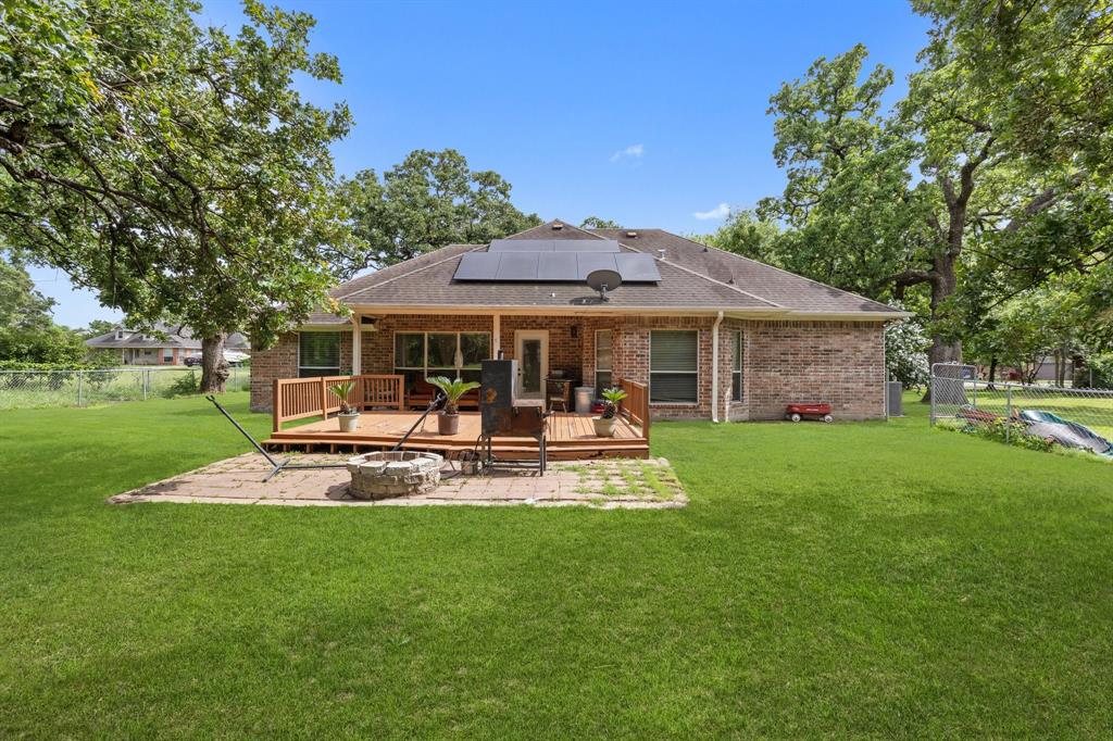 118 Cagle Quinlan, TX 75474 - Photo 16 of 23 a patio with a table and chairs under an umbrella