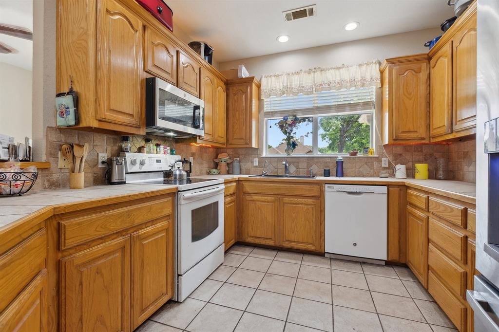 118 Cagle Quinlan, TX 75474 - Photo 6 of 23 a kitchen with a sink window and cabinets
