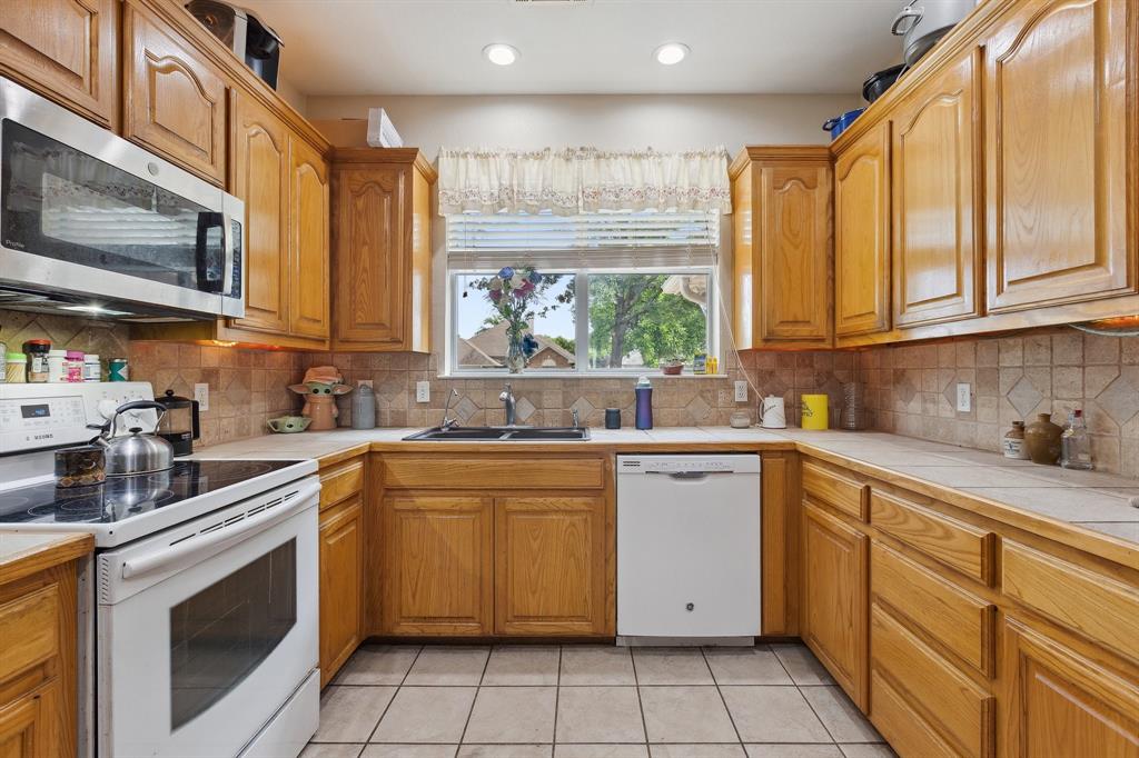 118 Cagle Quinlan, TX 75474 - Photo 7 of 23 a kitchen with a sink window and cabinets