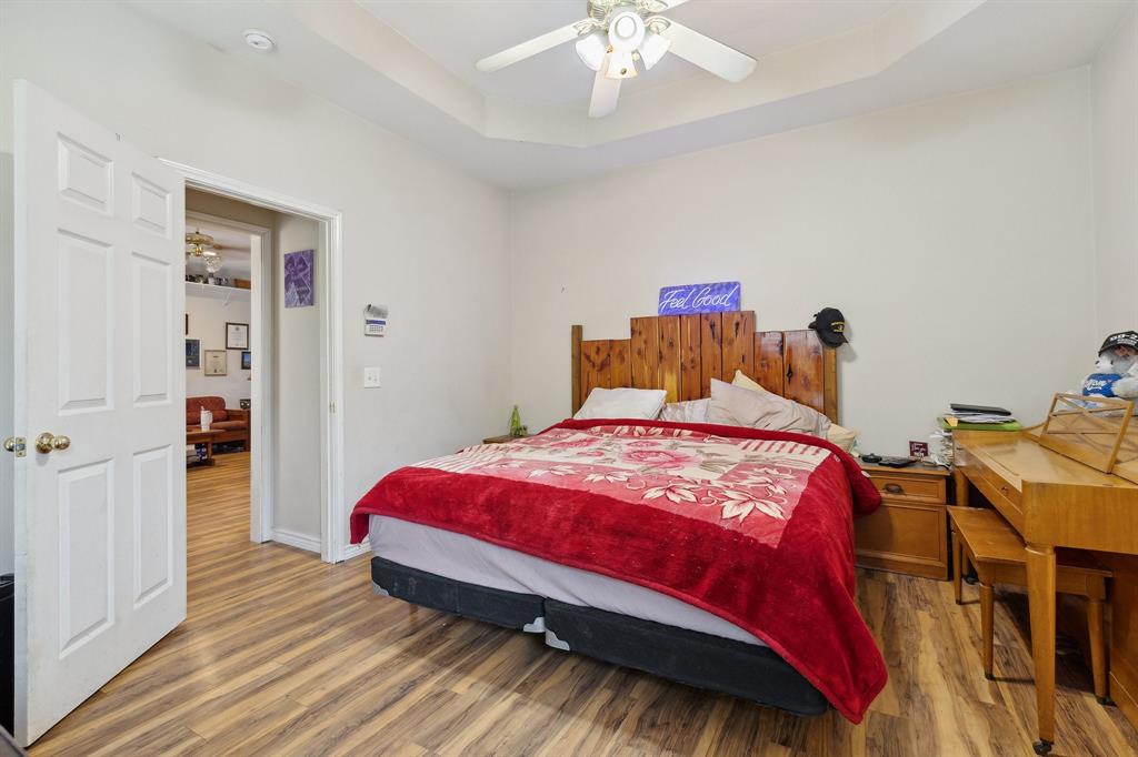 118 Cagle Quinlan, TX 75474 - Photo 10 of 23 a bedroom with a bed and a chandelier