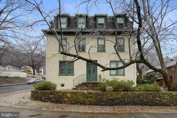 a front view of a houses with yard